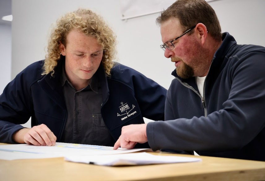 Naval Architects going over design plans in preparation for a consultation